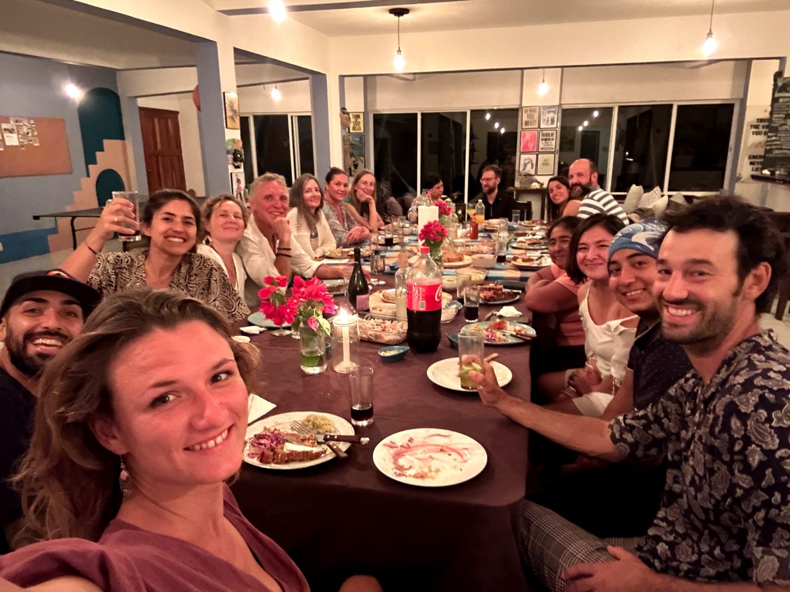 Full group sharing a meal at Pronoia's communal table